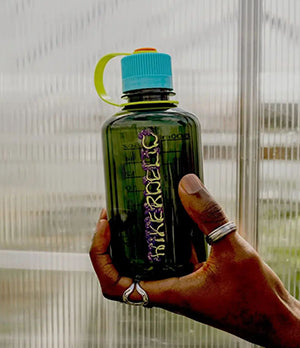 Hand holding a Nalgene bottle with vibrant design, showcasing durable, eco-friendly hydration for active lifestyles.