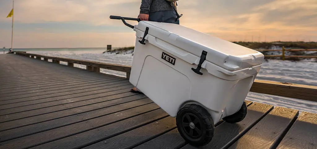 Man Wheeling a YETI Tundra Haul Cooler along a Pier