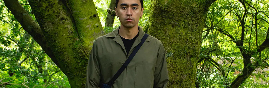 Man Wearing a WAWWA Jacket Shirt standing in front of a Tree