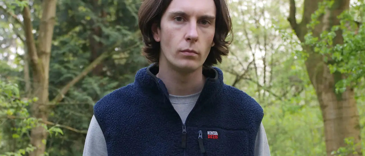 Man Standing in Forest Wearing Hikerdelic Fleece Gilets